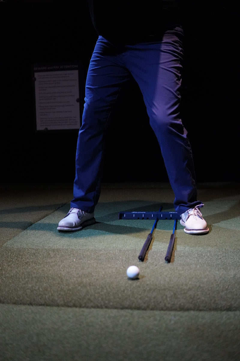 Perfect Your Path with Ground-Level Tunnels - Two alignment sticks in the ground-alignment tunnels to help with ball placement and stance