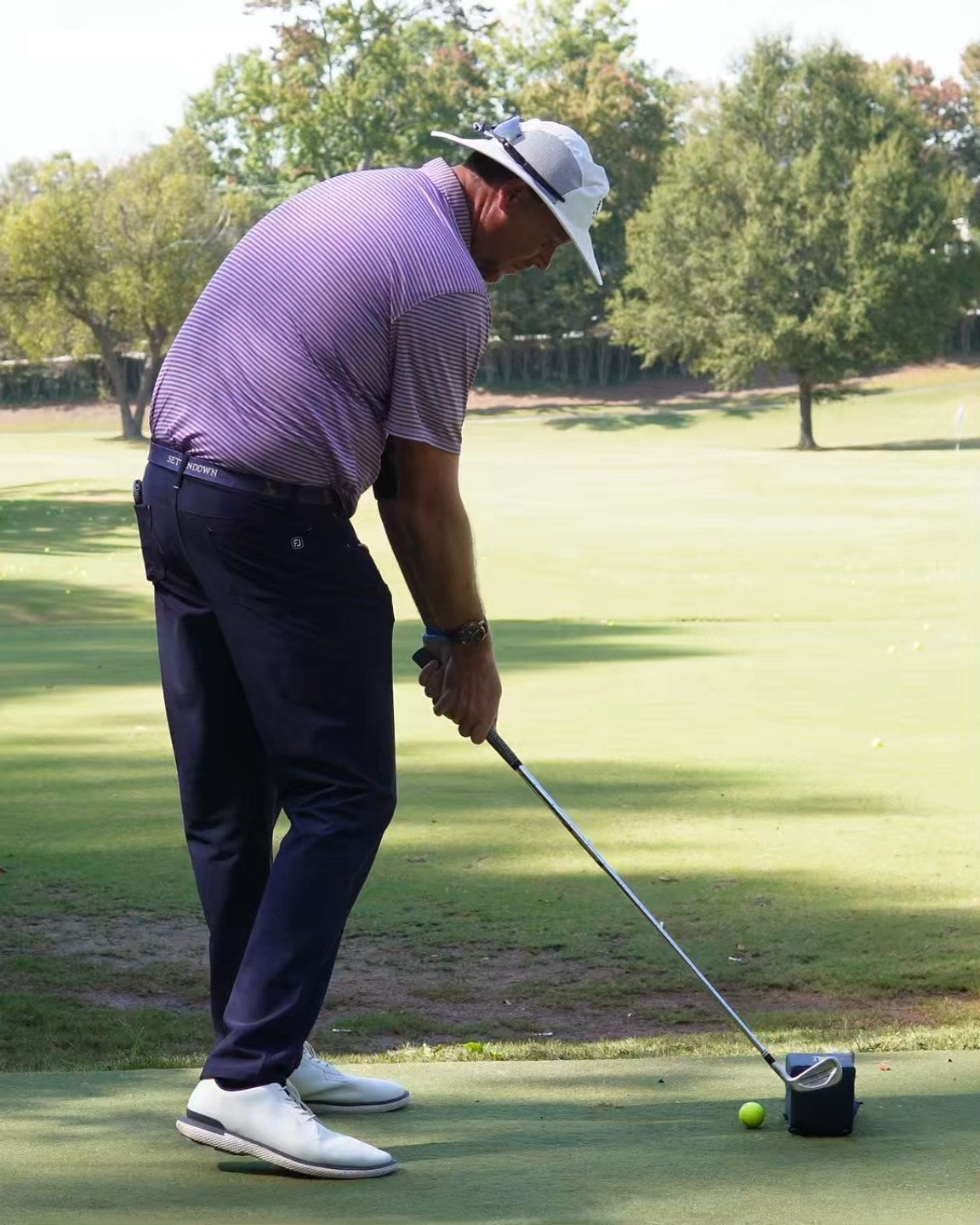 Professional golf instructor demonstrating training drills with PathPal system